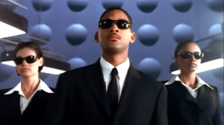 Agent J walks with two agents