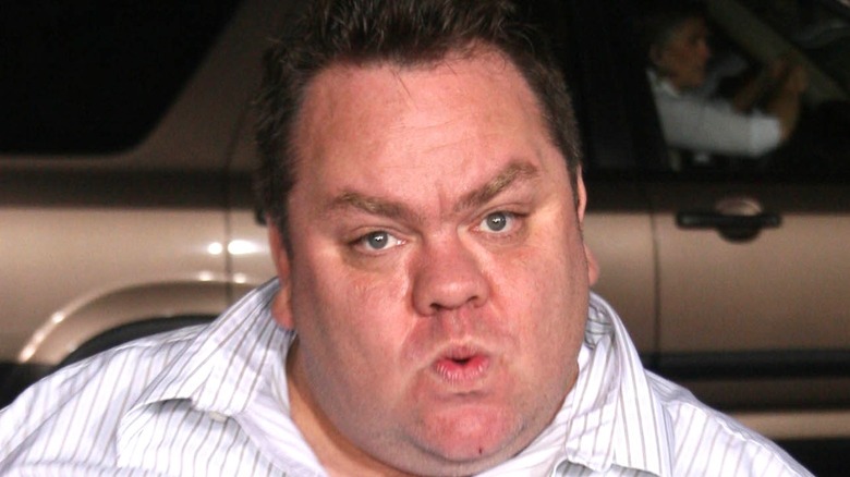 Preston Lacy in front of a car