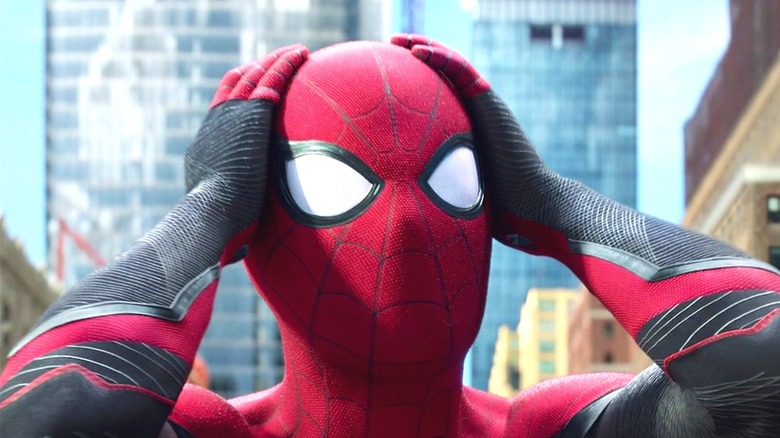 Spider-Man clutching hius Marvel Comics