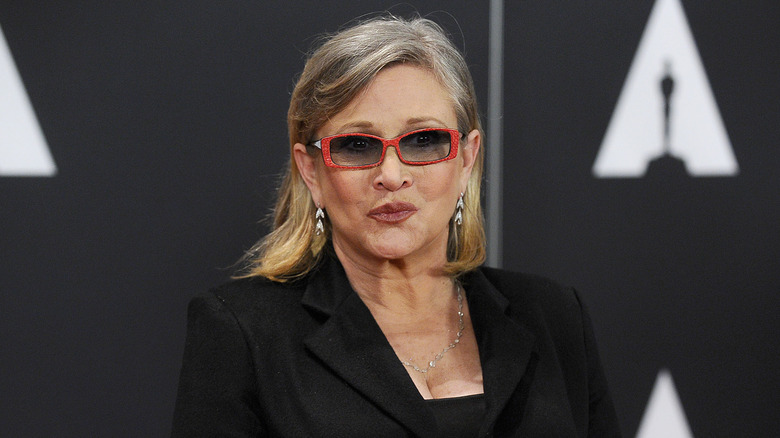 Carrie Fisher wearing red glasses