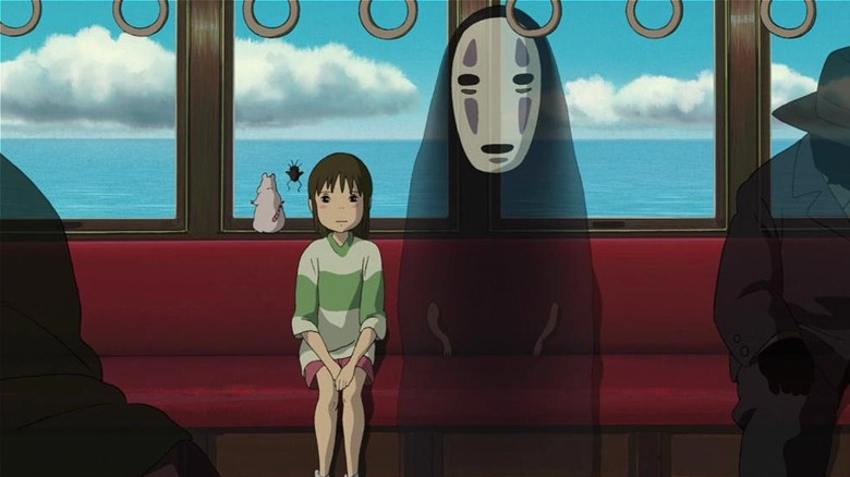 Chihiro and No Face sitting on the train in Spirited Away