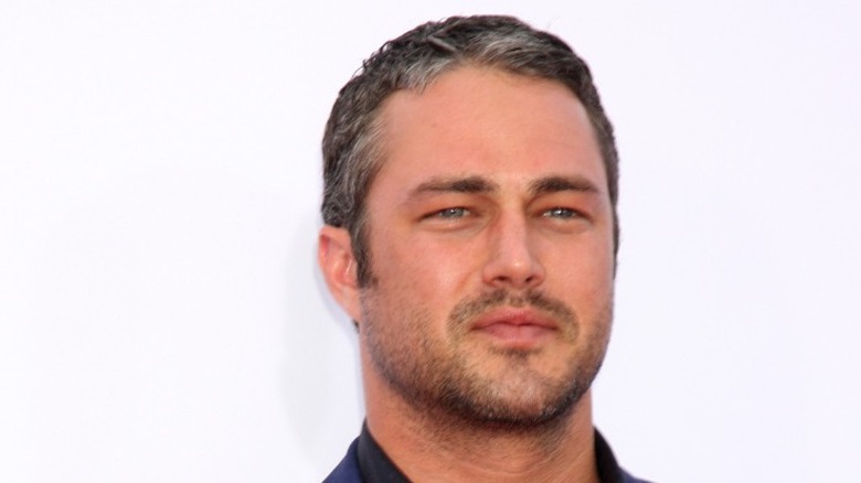 Taylor Kinney posing on red carpet