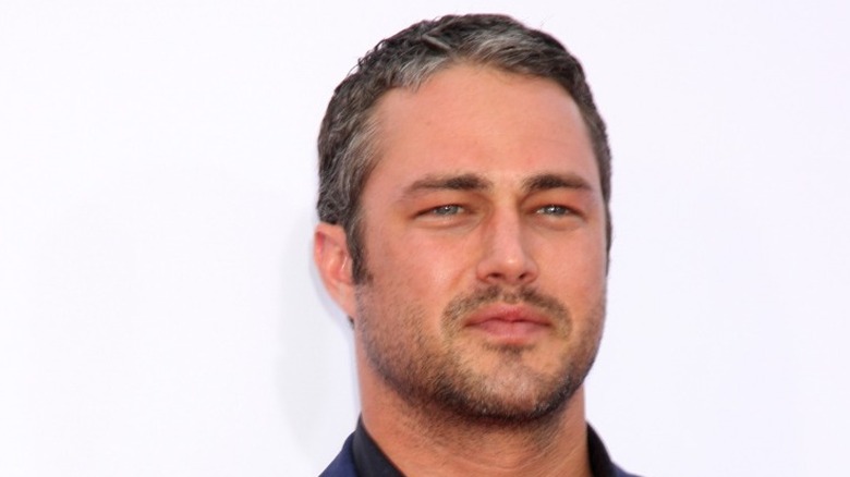 Taylor Kinney posing on red carpet