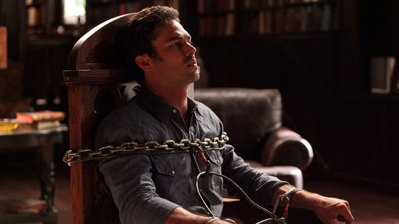 Taylor Kinney chained to chair