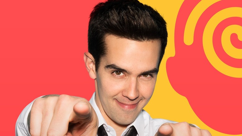 Michael Carbonaro pointing at camera