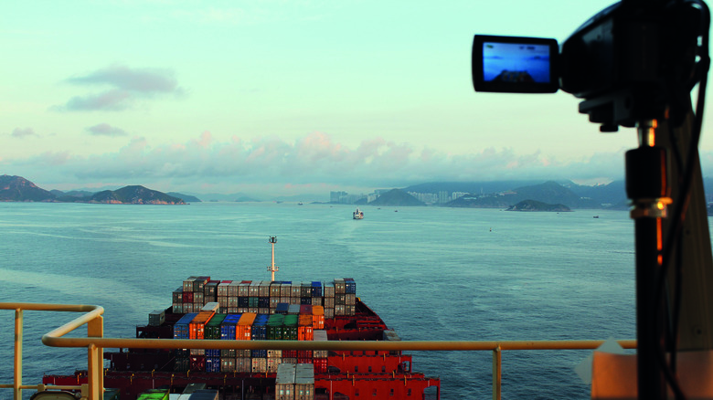 Filming freight ship on water