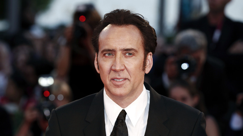 Nicolas Cage wearing a suit and tie