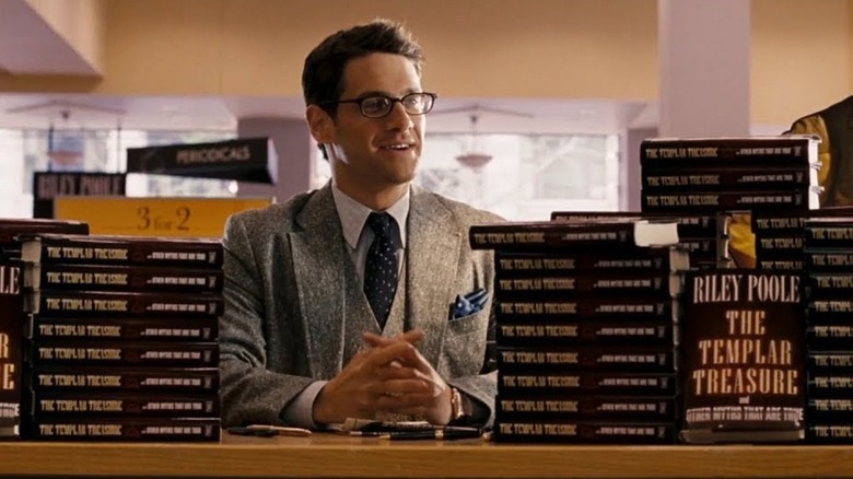 Justin Bartha with piles and piles of books National Treasure