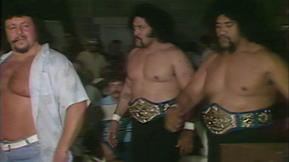 The Wild Samoans holding gold