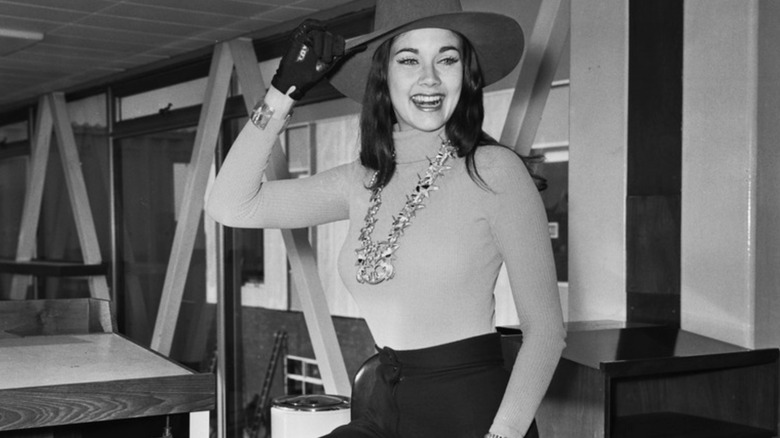 Young Lynda Carter stands in office