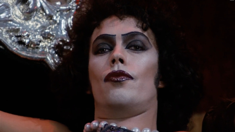 Frank-N-Furter smiling salaciously