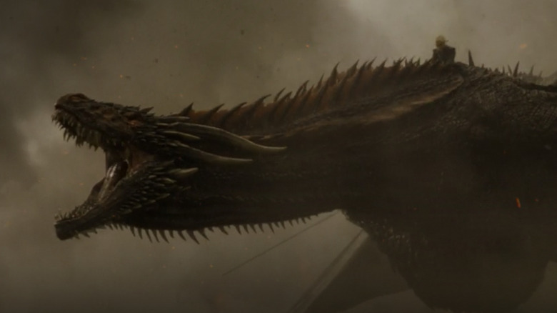 Daenerys riding Drogon amid smoke