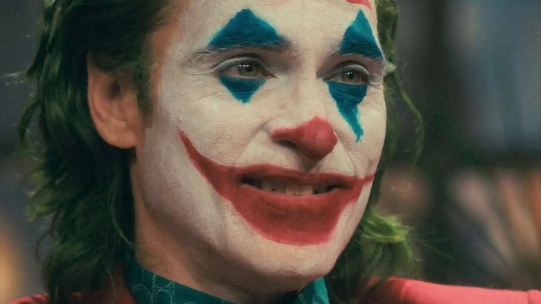 Joker sneering in face paint