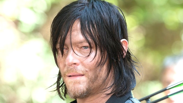 Daryl Dixon standing with arrows 