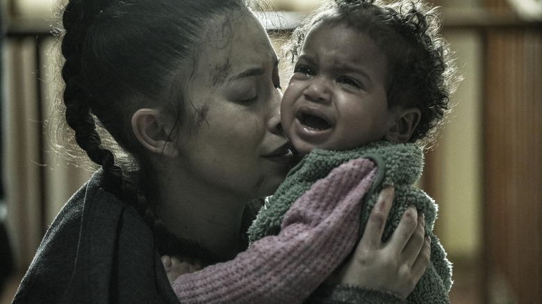 Rosita kisses a crying Coco on The Walking Dead