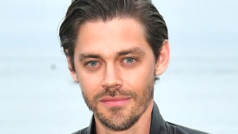 Tom Payne from The Walking Dead posing at an event