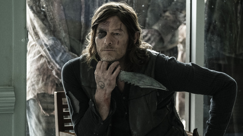Norman Reedus holding a knife