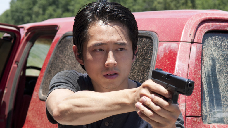 Glenn pointing a gun