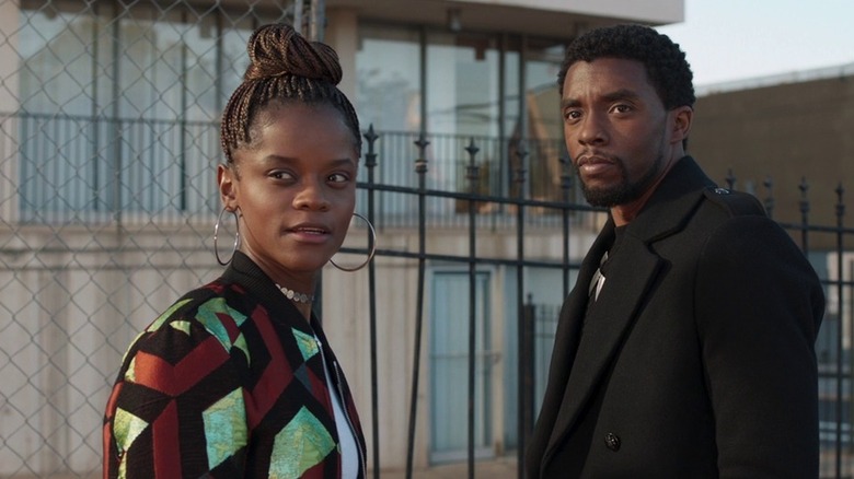 Shuri and T'Challa looking off camera in an American neighborhood
