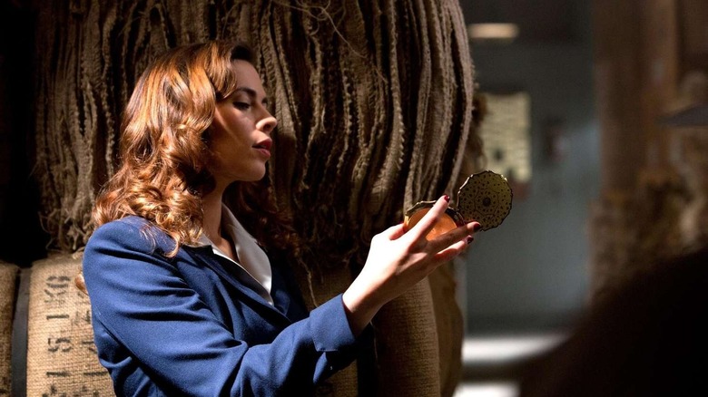 Peggy Carter using a mirror to peer around a corner