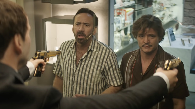 A wax Nic Cage holds guns