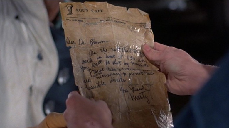 Marty McFly holding a taped-up letter in Back to the Future