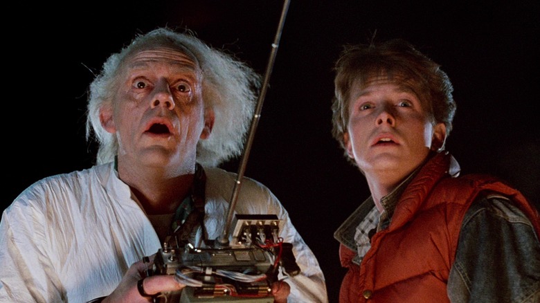 Doc Brown holding a remote controller and Marty McFly looking surprised in Back to the Future