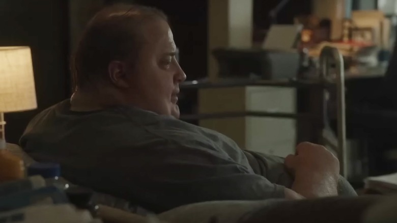 Charlie sits on his couch
