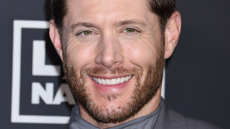 Jensen Ackles smiling for press