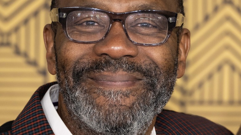 Lenny Henry smiles in glasses