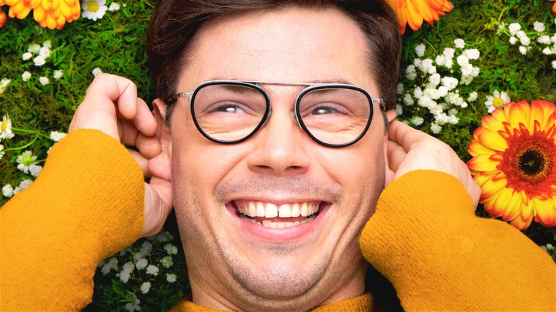 Ryan smiling in flowers