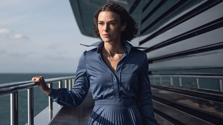 Lo Blacklock standing on ship deck looking out in The Woman in Cabin 10