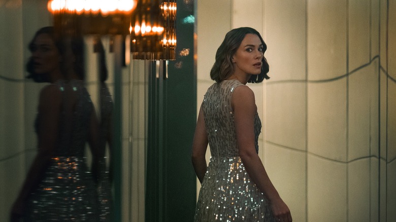 Lo wearing a gown looking behind her in The Woman in Cabin 10