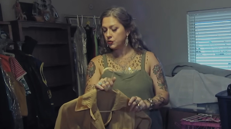 Danielle Colby inspecting an old jacket