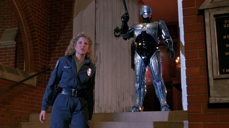 Robocop standing with an actress in Robocop 3