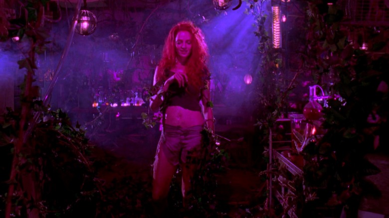 Poison Ivy grinning after poisoning Jason Woodrue in Batman & Robin (1997)
