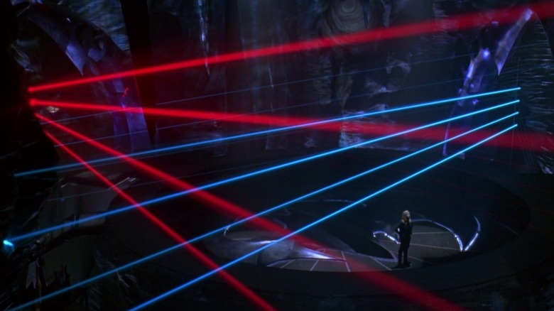 Barbara standing in the Bat Cave surrounded by lasers in Batman & Robin (1997)