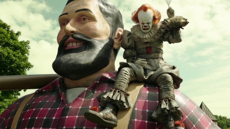 Pennywise the Clown sits on Paul Bunyan's shoulder
