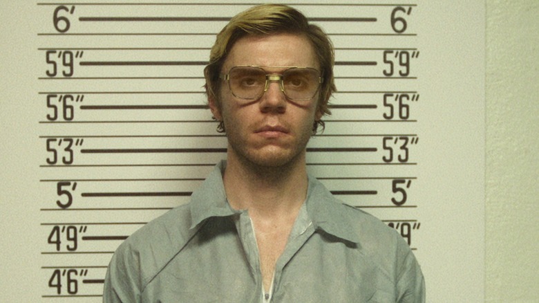 Jeffrey Dahmer posing for a booking photo in "Monster: The Jeffrey Dahmer Story."