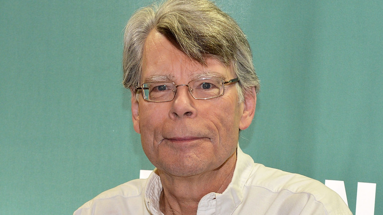 Stephen King wearing white shirt and glasses