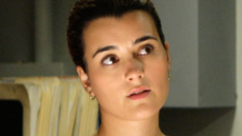 A young woman in a lab full of medical records