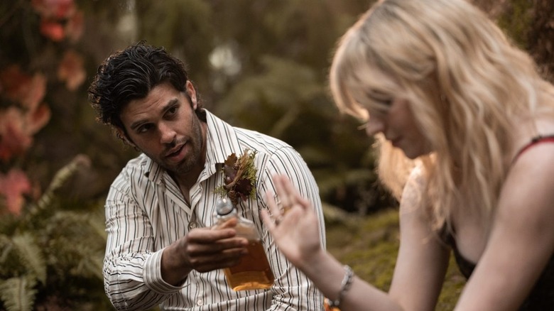 Ben offering Natalie a bottle of liquor 