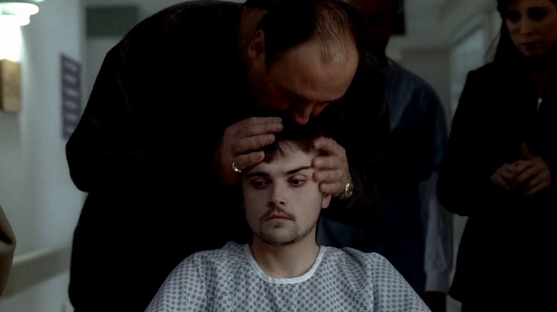 Tony kisses the head of a very pale looking AJ at the hospital