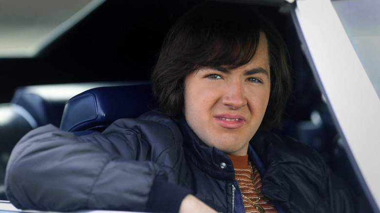 Young Tony staring out a car window