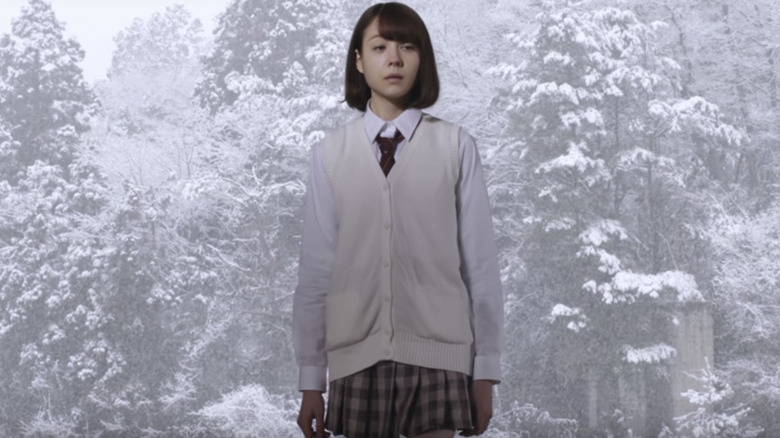 Mitsuko stands in snow