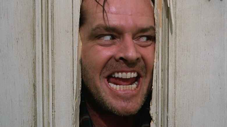 Jack peers through a hole in the door in 