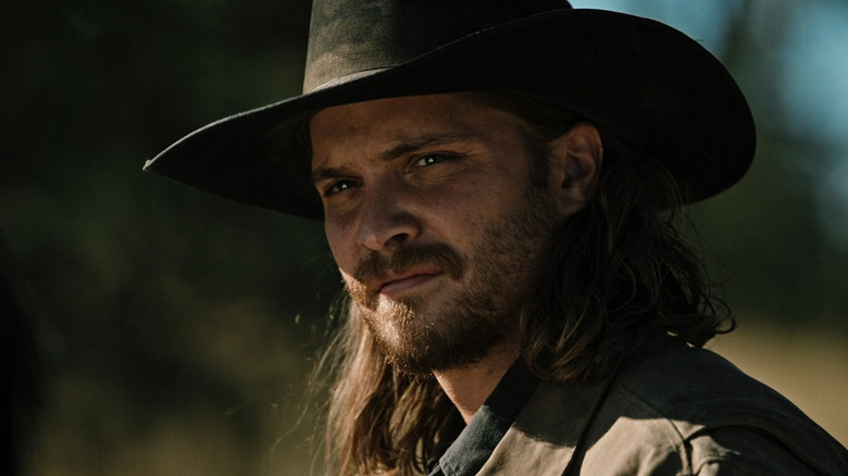 Kayce looks over his shoulder