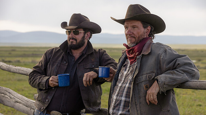 Rip and Delbert lean against a fencepost in "Yellowstone"