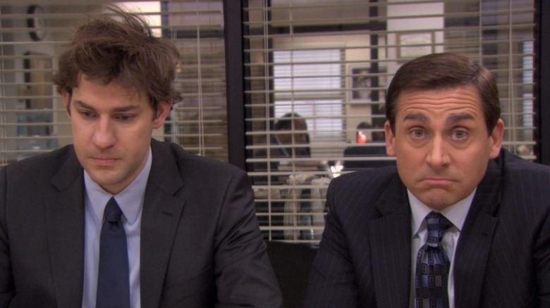 Jim Halpert sitting with Michael Scott