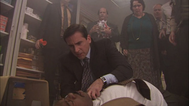 Michael Scott helping Stanley Hudson